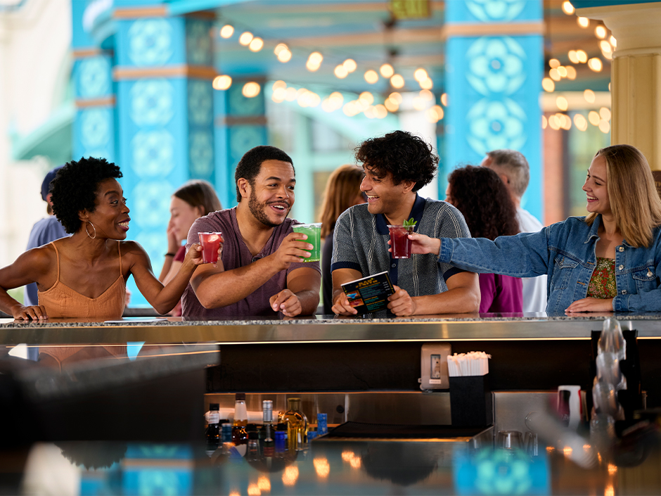 A group of friends toasting in Bar Zenith in Celestial Park at Epic Universe