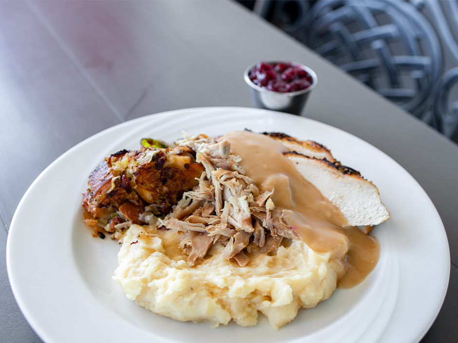 A kids' plate of roasted turkey, stuffing, gravy, Brussels sprouts, smashed potatoes, and cranberry sauce at Lombard's Seafood Grille for Thanksgiving at Universal Studios Florida.