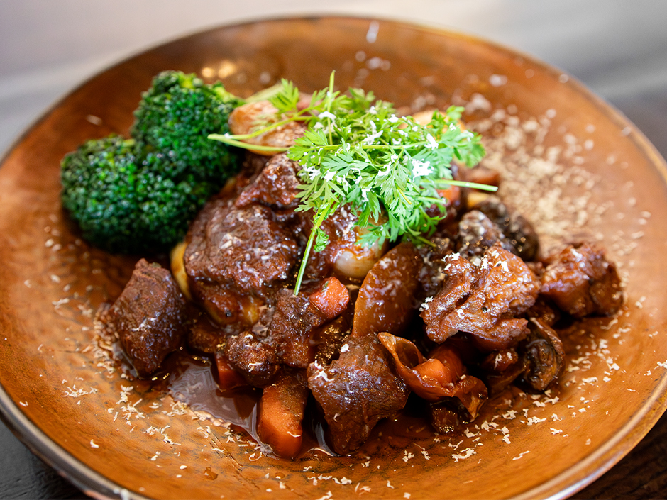 A plate of Chocolate Beef Bourguignon for National Chocolate Day at The Toothsome Chocolate Emporium & Savory Feast Kitchen at Universal CityWalk.