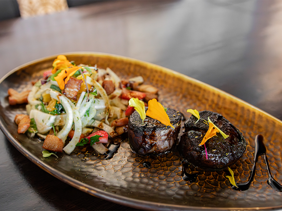 A plate of Cocoa Chili Diver Scallops for National Chocolate Day at The Toothsome Chocolate Emporium & Savory Feast Kitchen at Universal CityWalk.