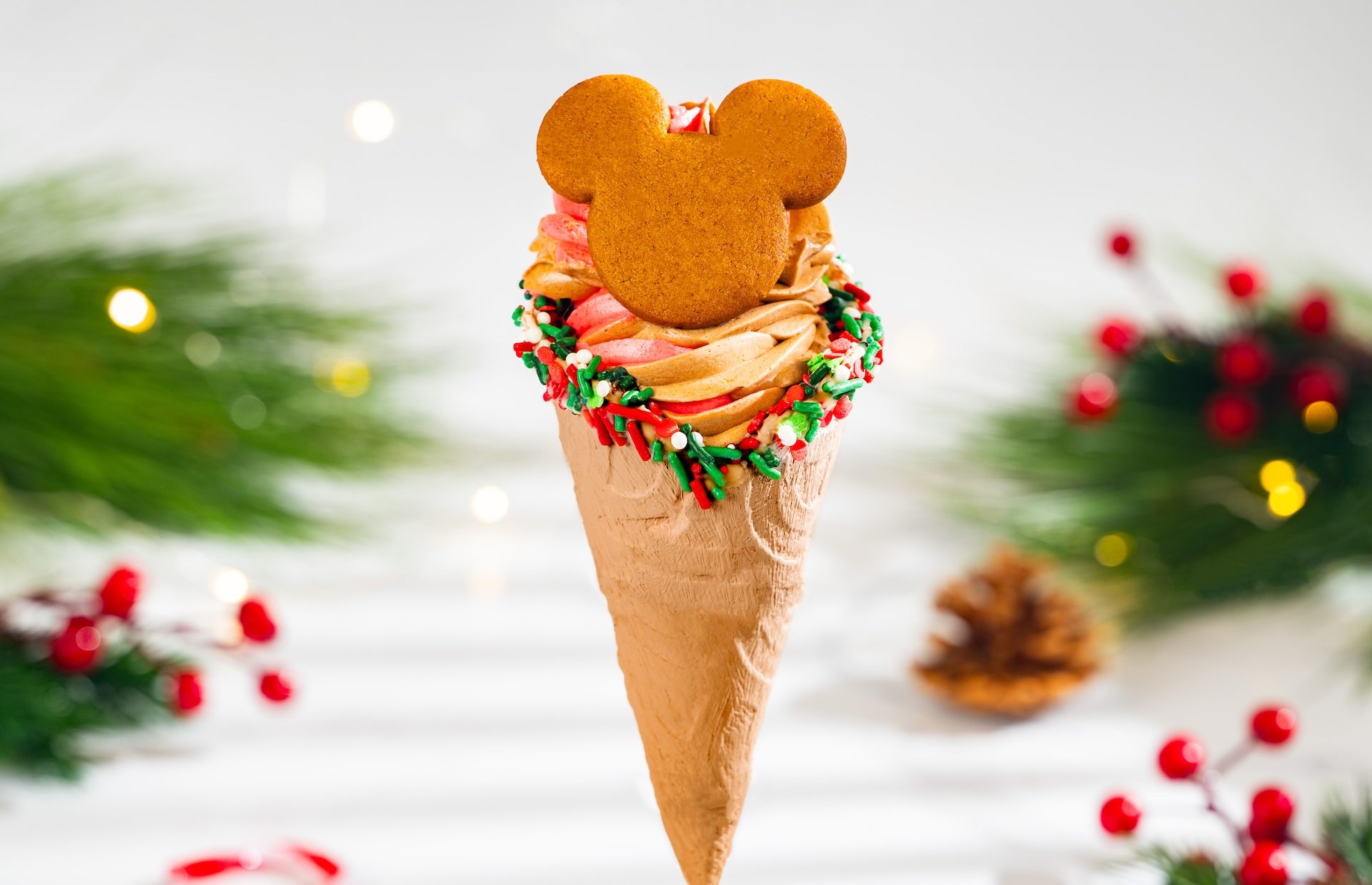 Mickey Gingerbread Cone: Gingerbread cone with chocolate soft-serve, DOLE Whip pomegranate, holiday sprinkles, and gingerbread Mickey (New) 