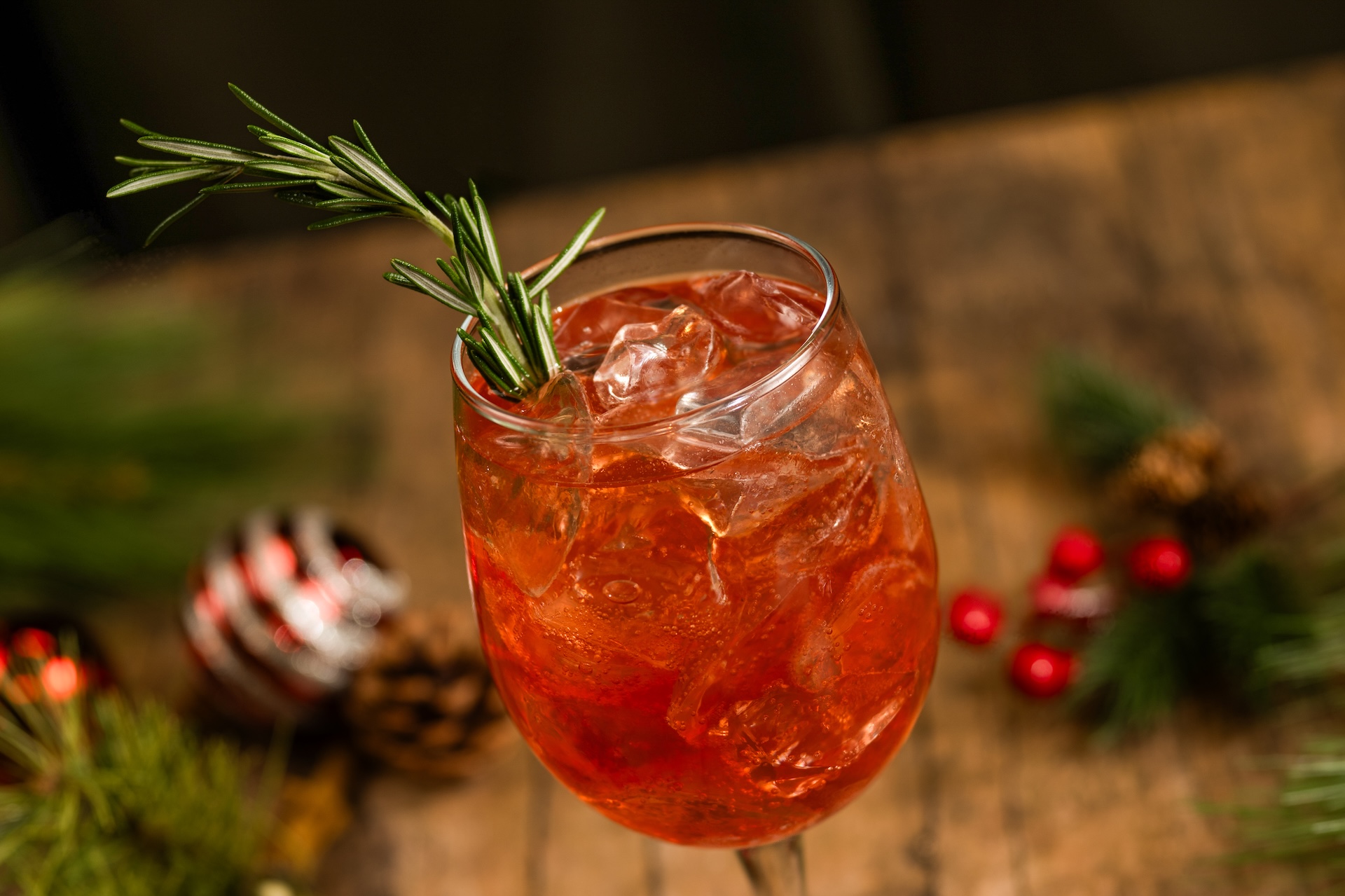 Holiday Spritz: Aperol Liqueur, cranberry juice, smoked cranberry syrup, and Prosecco garnished with a rosemary sprig (New) 