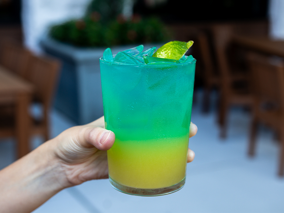 A hand holding the Air Support Fizz mocktail at Bigfire in Universal CityWalk for Veterans and Military Families Appreciation Month.