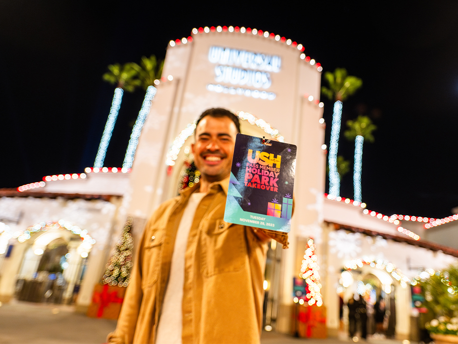 A guest holds up a pass for the Pass Member Holiday Takeover event.